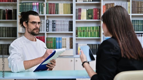 Young male mental health specialist working with mature female patient