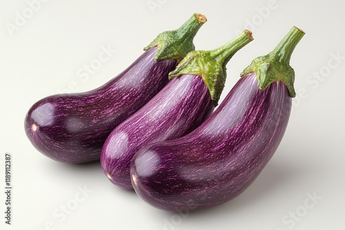 Wallpaper Mural Three fresh, ripe, purple eggplants with green stems, arranged on a white background. Torontodigital.ca