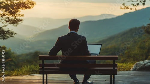Wallpaper Mural Businessman working on laptop outdoors, enjoying mountain view at sunset. Torontodigital.ca