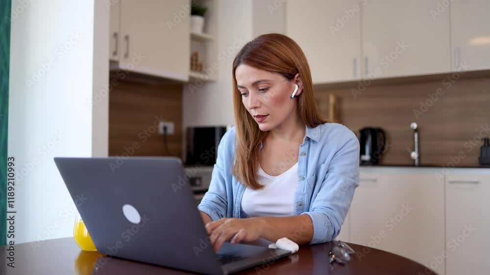 Beautiful woman working online at home and making a video call on her laptop Beautiful woman working online at home and making a video call on her laptop