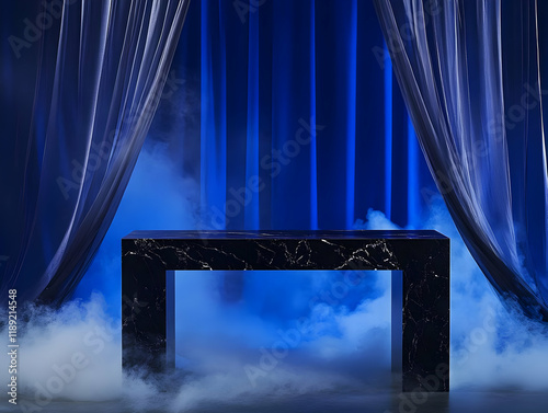 A dramatic stage setup featuring a black table amidst smoke and blue curtains.