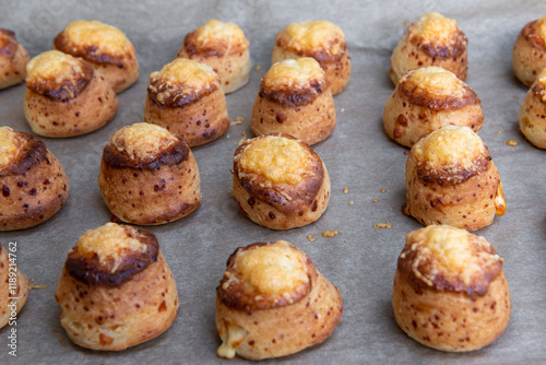 Pogaca stuffed with cheese. A full tray of fresh Pogaca traditional Eastern European salty buns with cheese - Pogace. photo