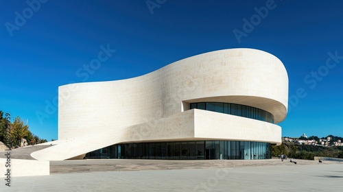 A magazine cover design featuring a modern, minimalist building under a clear blue sky.