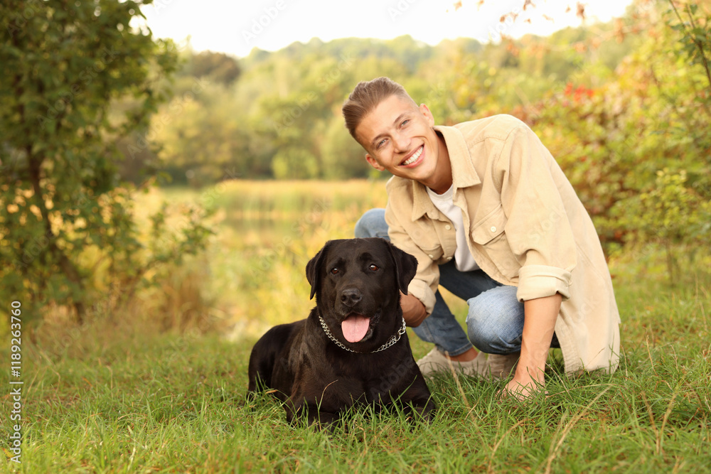 Smiling man with cute dog outdoors on autumn day. Space for text Smiling man with cute dog outdoors on autumn day. Space for text