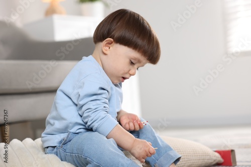 Little boy playing with matches at home. Child in danger photo