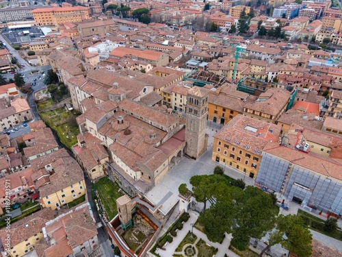 Fototapeta Naklejka Na Ścianę i Meble -  Aerial view of Rieti's historic old town in Italy, with the cathedral Santa Maria Assunta standing prominently in the center. Narrow medieval streets and terracotta rooftops surround the cathedral
