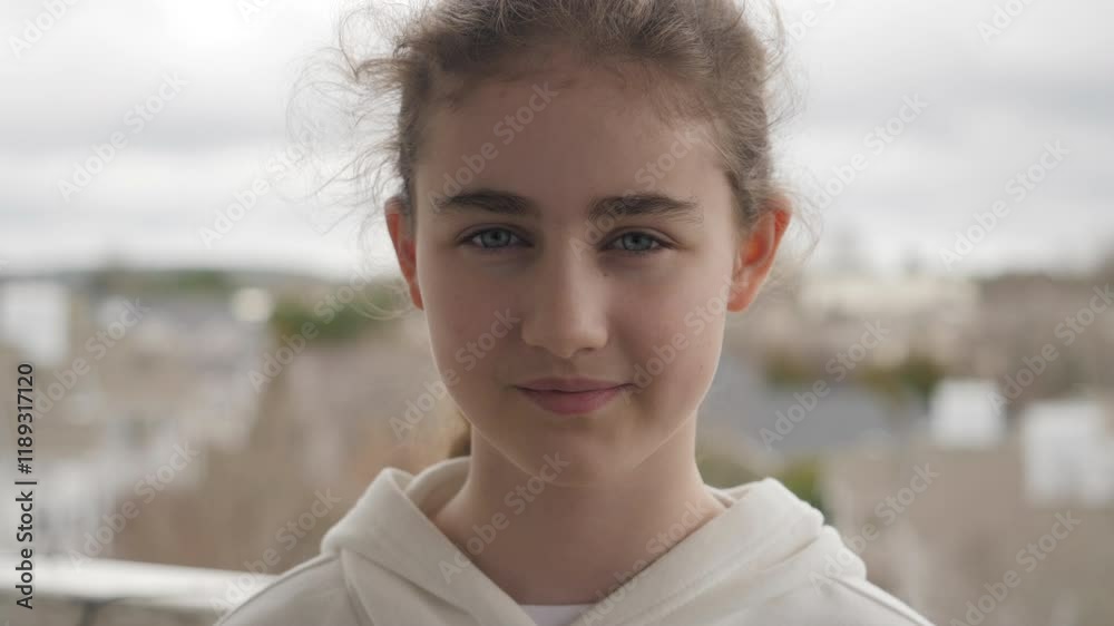 Portrait of Teenage Girl Looks Friendly at Camera Smiling Standing on Outdoors Near Home. Happily Child at Outdoors. Inquisitive Little Girl Portrait. Face Contemplative Child Smile Freedom Wellness. Portrait of Teenage Girl Looks Friendly at Camera Smiling Standing on Outdoors Near Home. Happily Child at Outdoors. Inquisitive Little Girl Portrait. Face Contemplative Child Smile Freedom Wellness.