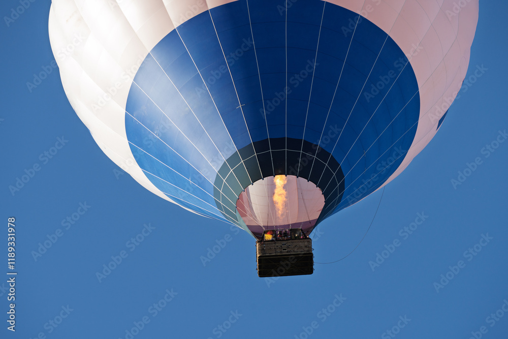 Fototapeta premium Flying colorful hot air balloon in the blue sky