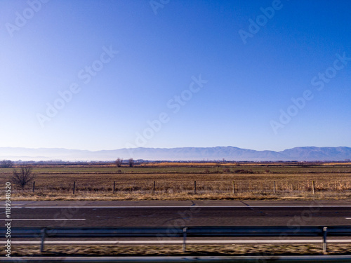 View to field and mountain from highway