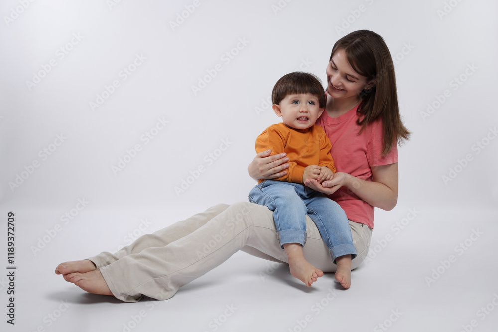 Happy mother with her cute little son on white background Happy mother with her cute little son on white background