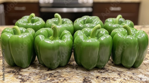 Freshly harvested green bell peppers arranged neatly on a kitchen counter