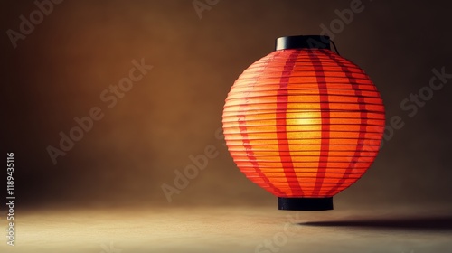 Red paper lantern hanging in dim light creating a cozy atmosphere in a tranqu...