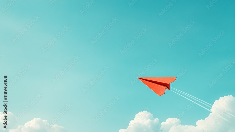 Fototapeta premium Red paper airplane flying in a blue sky