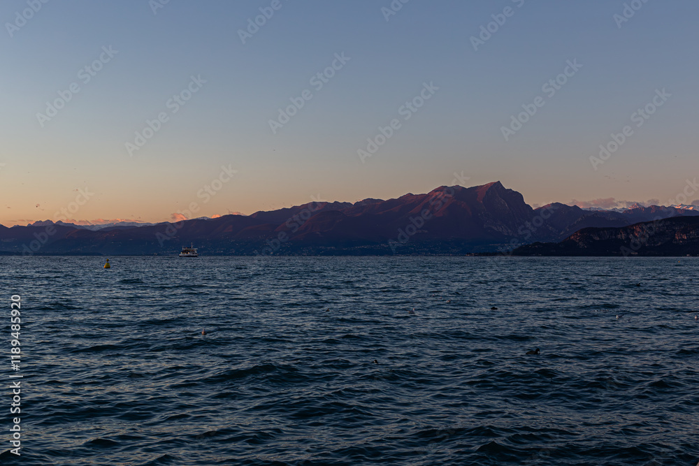 Serene atmosphere: Lake Garda at sunset, view from Lazise. Serene atmosphere: Lake Garda at sunset, view from Lazise.