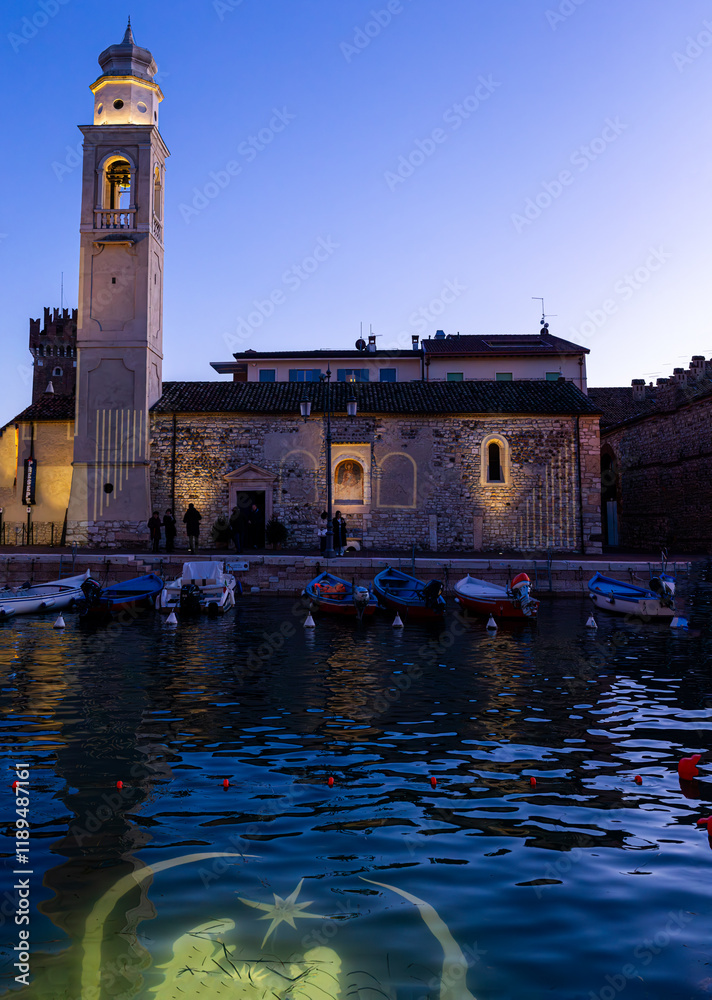 Lazise: nocturnal glimpse of the harbor and the Romanesque church.