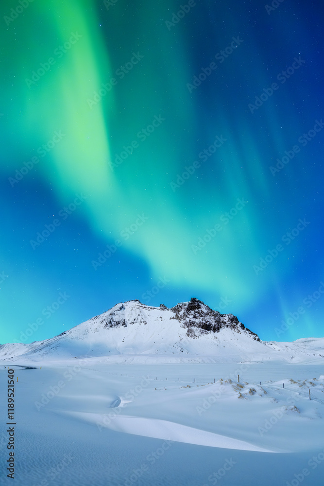 Aurora Borealis. Northern lights. Nature. Scandinavian countries. Snow and ice on the mountains. Winter landscape on the north. Photo for background, wallpaper, postcards.