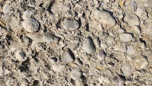 Structure of a conglomerate rock in a river bed as a design 