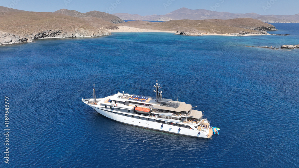 Aerial drone photo of luxury yacht anchored in tropical exotic island bay with emerald sea and secluded sandy beaches Aerial drone photo of luxury yacht anchored in tropical exotic island bay with emerald sea and secluded sandy beaches