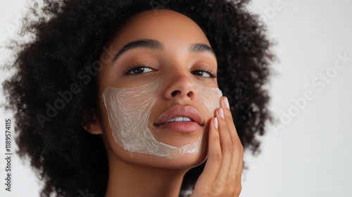 Woman applying detoxifying face mask for skincare routine and beauty treatment photo