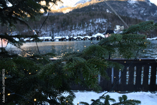 winter landscape with a lake and wooden houses on the shore, the roofs of which are covered with snow photo