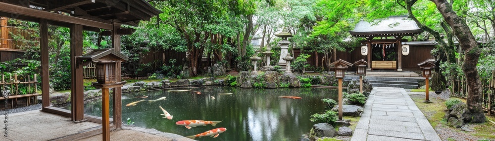 Serene Japanese Garden Featuring a Koi Pond and Elegant Traditional Architecture Serene Japanese Garden Featuring a Koi Pond and Elegant Traditional Architecture