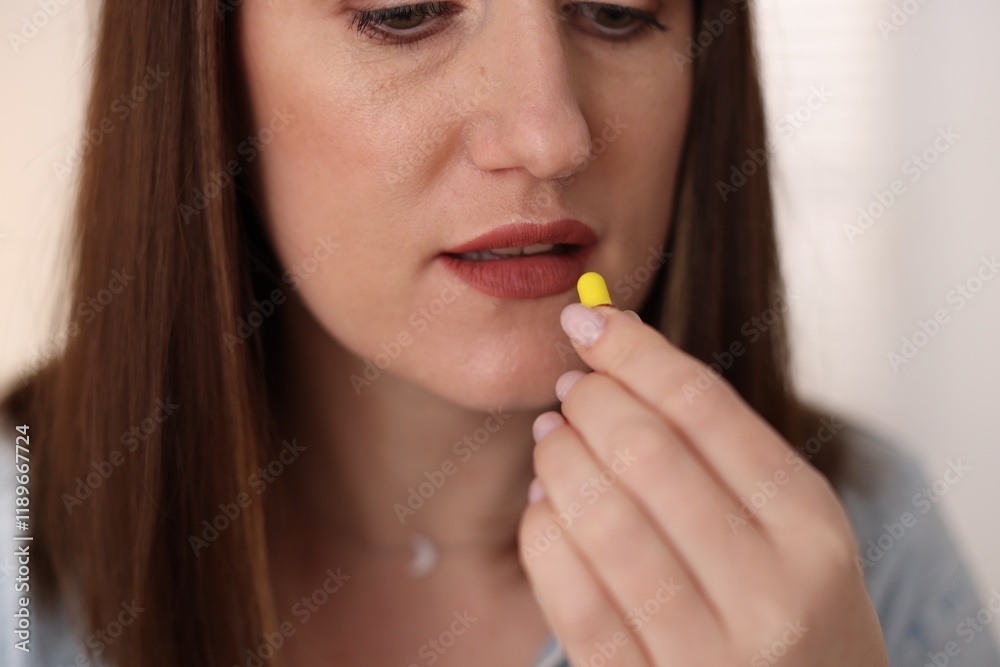 Woman taking medical pill at home, closeup Woman taking medical pill at home, closeup