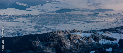 View of the city of Miercurea Ciuc in winter, in front with the forest and the Kossuth rock. Romania, Harghita country.  photo