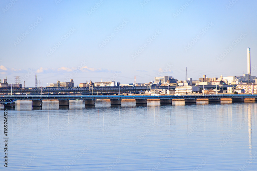 Osaka Urban Skyline with Train Bridge and Water Reflections at Early Morning Osaka Urban Skyline with Train Bridge and Water Reflections at Early Morning