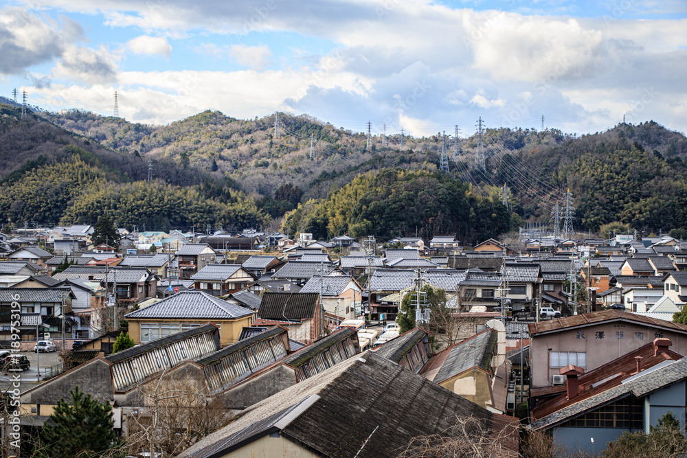 Naklejka premium Traditional Japanese Townscape with Mountain Backdrop, Izushi Castle Town, Toyooka, Japan