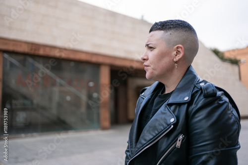 Lesbian woman wearing black leather jacket showing masculinity and pride
