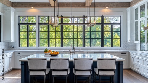 A front view of a bright kitchen room interior showcases a panoramic window that floods the space with natural light. photo