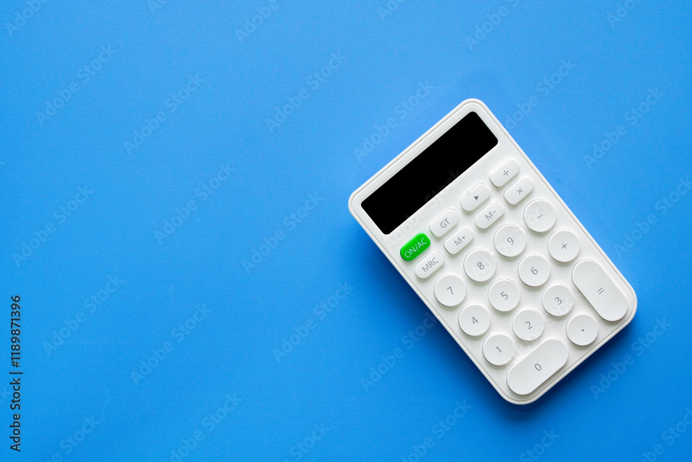 Top view White calculator on blue sky background with copyspace,mockup for financial, accounting,education,business planning,TAX,mathematics,investment,advertising for web,banner,design. Top view White calculator on blue sky background with copyspace,mockup for financial, accounting,education,business planning,TAX,mathematics,investment,advertising for web,banner,design.