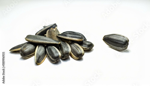 A small pile of sunflower seeds on a white background.