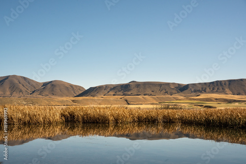 The arid extreme countryside around the shore of alpine Lakes in the Ashburton hills Hakatere conservation area photo