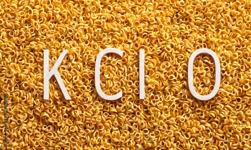 Yellow grain texture, chemical formula KClO, white text overlay, golden particles, macro photography, scientific background, crystalline structure, potassium chlorate, oxidizing agent