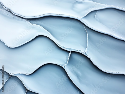 Abstract lines created by windblown snow on a frozen plain, soft light highlighting subtle patterns and textures photo