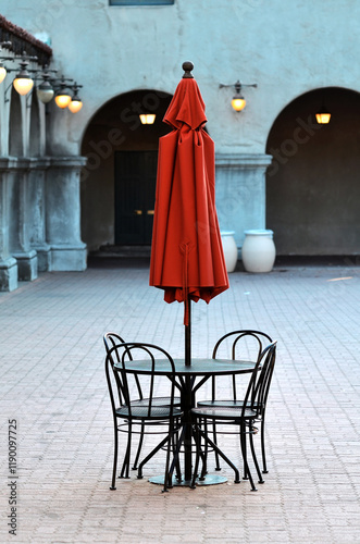 public cafe table set with red umbrella 
