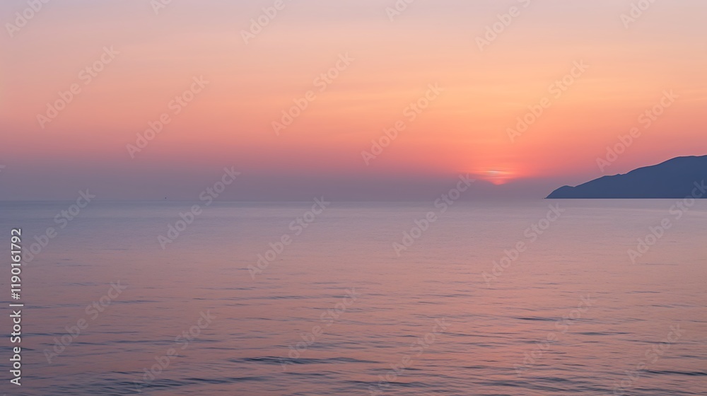 Naklejka premium Serene Sunset Over Calm Ocean and Distant Mountain