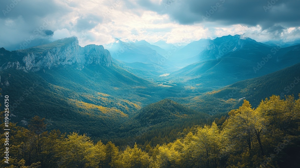 Majestic mountain range with sunlight breaking through the clouds casting ethereal glow over valley below Majestic mountain range with sunlight breaking through the clouds casting ethereal glow over valley below