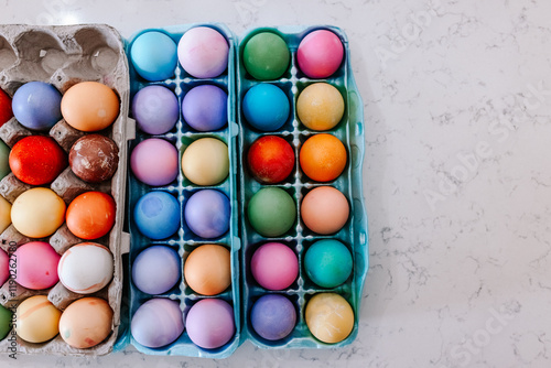 Dyed Easter Eggs in Egg Carton on Counter photo