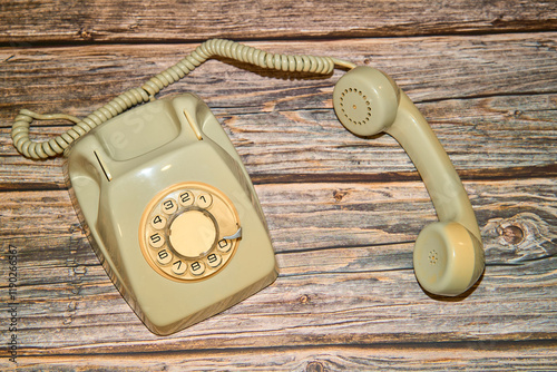 old telephone unhooked on a wooden table