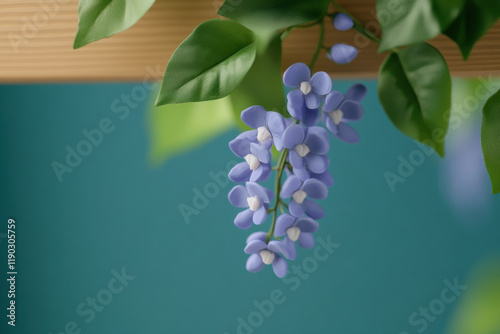 Claymation flower, A high-fidelity claymation image featuring a graceful wisteria vine draping elegantly, perfect for artistic and botanical themes. photo