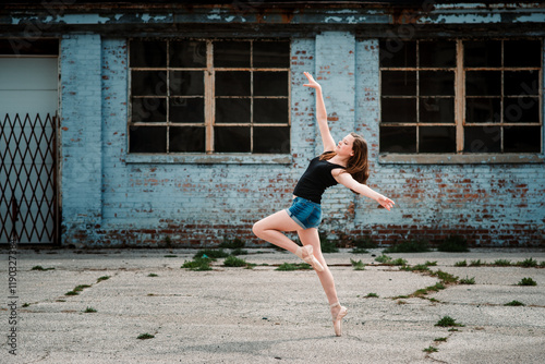 Ballet dancer in point shoes in industrial setting photo