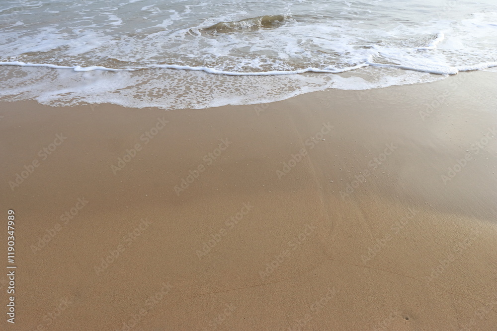 waves crashing on shore of sandy beach on a cloudy day waves crashing on shore of sandy beach on a cloudy day