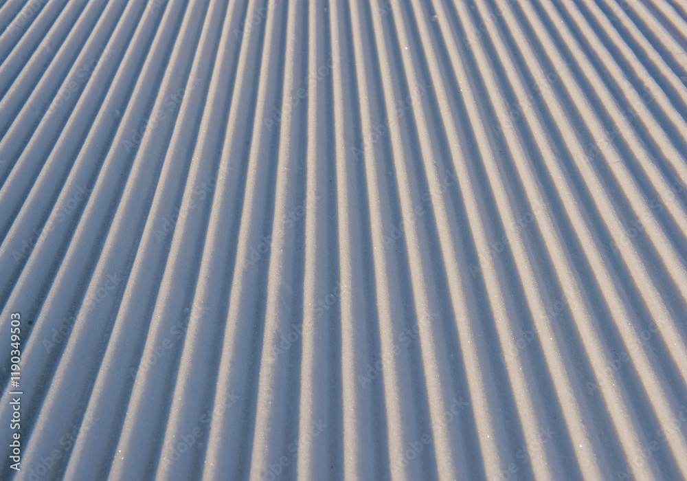 Obraz premium close-up of a groomed ski slope with striped relief