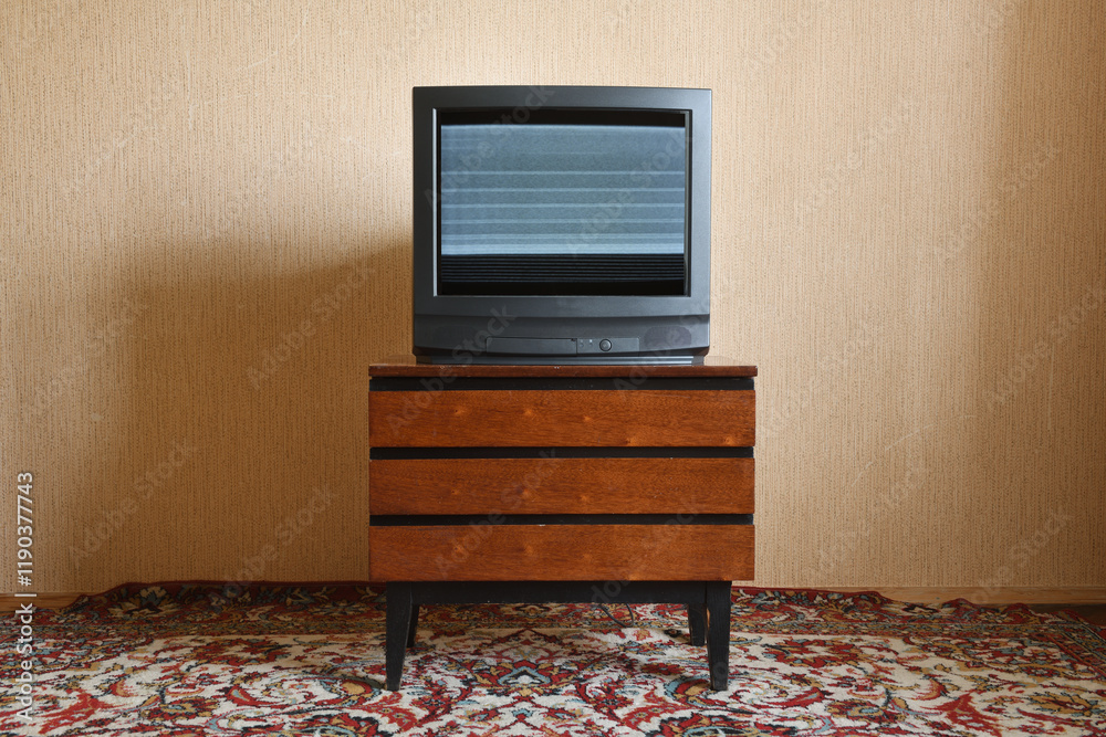 Fototapeta premium Old TV with clutter on the screen on an old table, vintage design in 80s and 90s style.