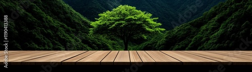 Serene Mountain Vista: A solitary lush green tree stands majestically in a deep mountain valley, framed by a rustic wooden deck in the foreground, creating a serene and inviting scene.  photo