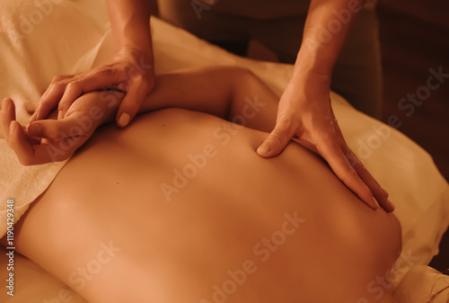 Wallpaper Mural Hands of female chiropractor massaging shoulders of young woman lying on massage table. Concept of physical therapy treatment, neck pressure point. Soft focus, blurred, noise effect Torontodigital.ca