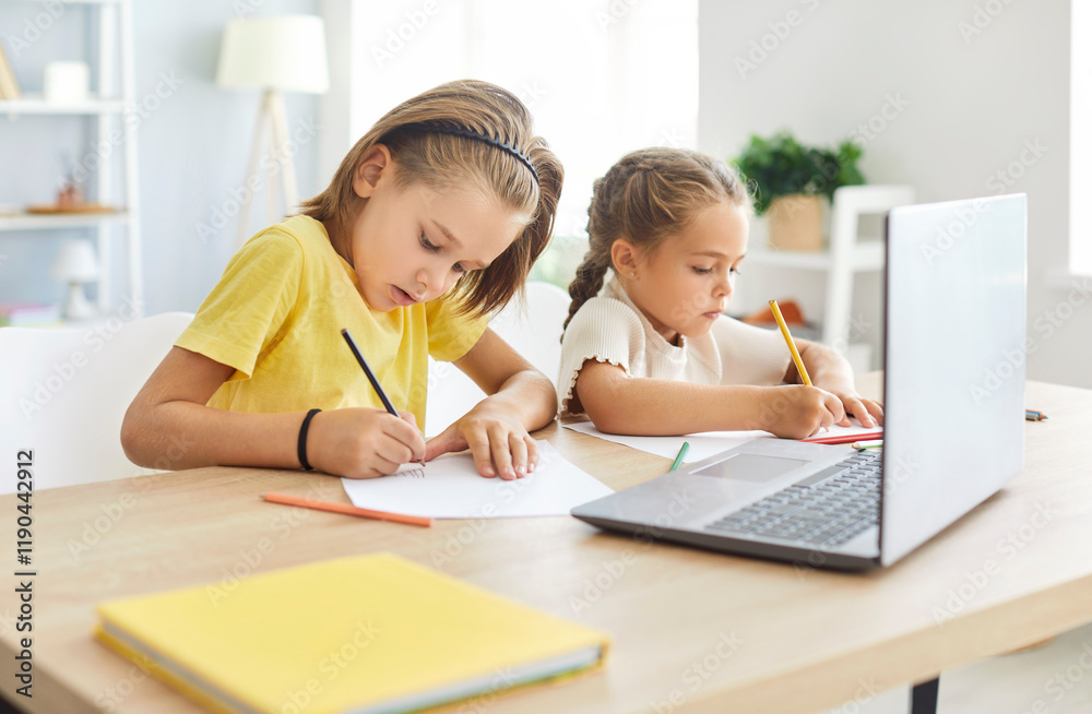 Small preschooler children, girl and boy sitting at desk drawing, writing, study online on laptop, smart little kids learning handwrite using internet lessons on quarantine, happy homeschooling Small preschooler children, girl and boy sitting at desk drawing, writing, study online on laptop, smart little kids learning handwrite using internet lessons on quarantine, happy homeschooling