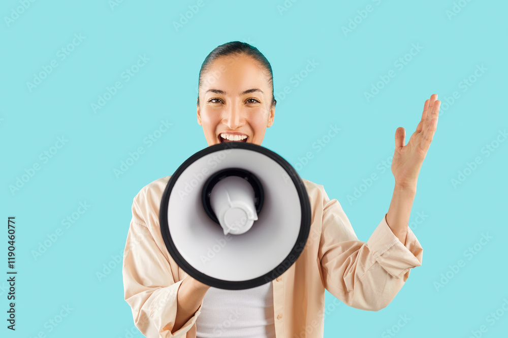 Studio shot of happy young Asian woman screaming in megaphone. Cheerful young girl isolated on bright blue background holding loud speaker in hand, looking at camera and talking with amplified voice Studio shot of happy young Asian woman screaming in megaphone. Cheerful young girl isolated on bright blue background holding loud speaker in hand, looking at camera and talking with amplified voice